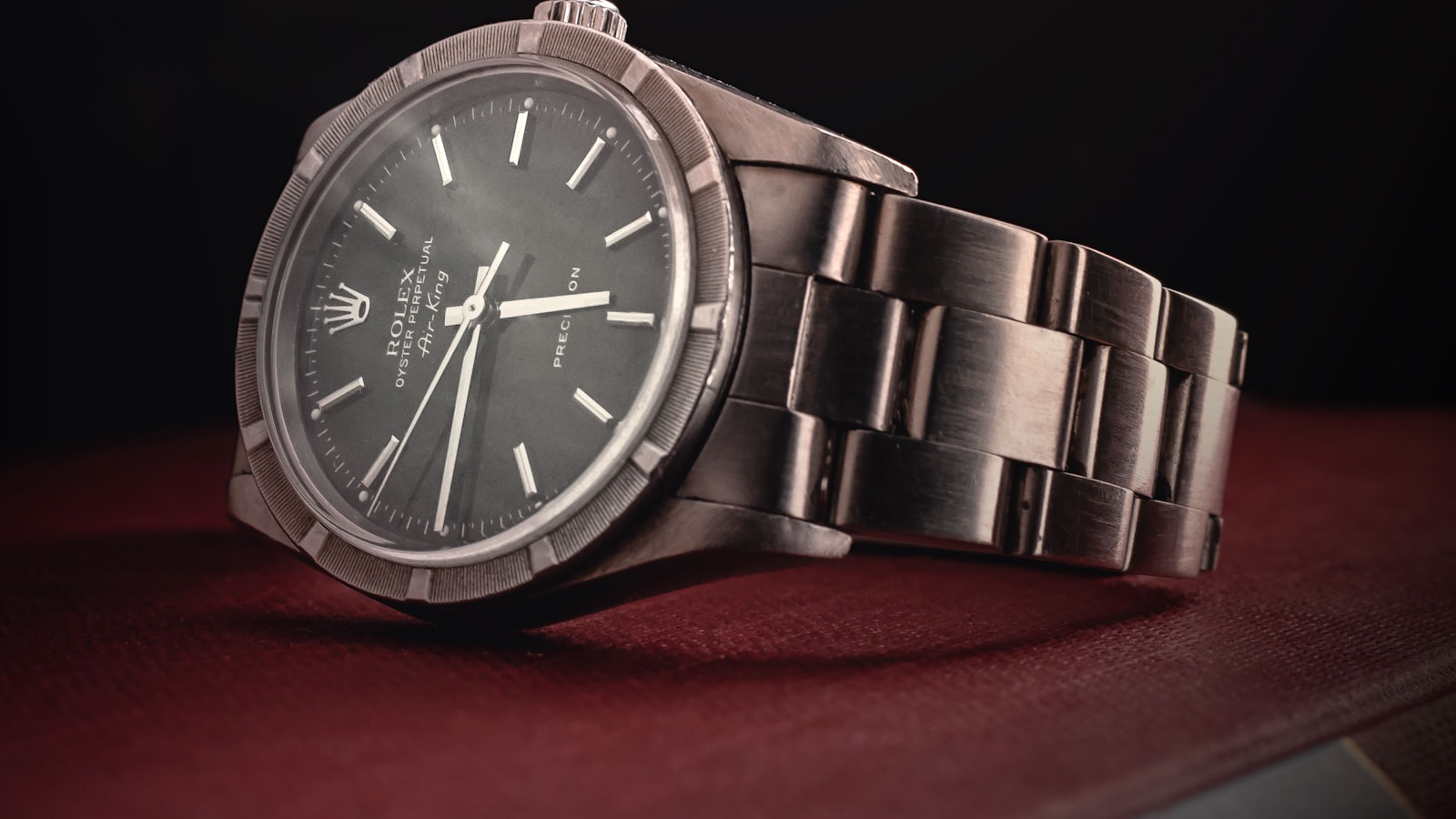 Dive watch resting on a wet surface with water droplets